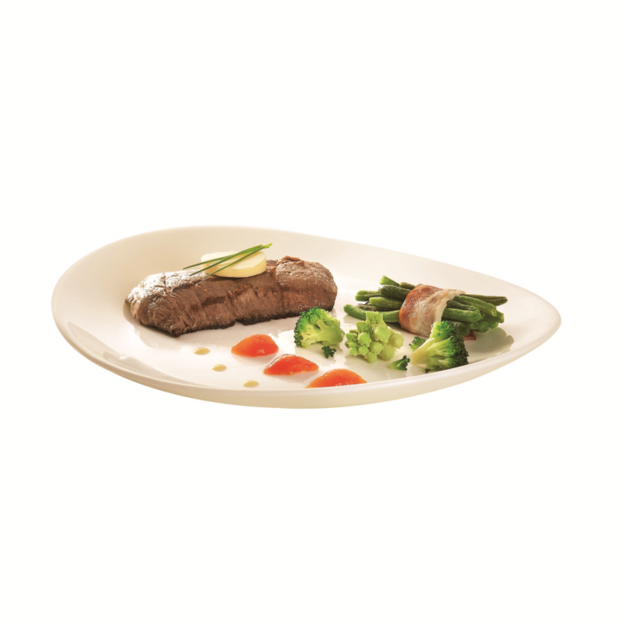 An oval white ceramic plate with a raised rim, styled with a cooked beef steak, broccoli florets, asparagus wrapped in bacon, and small orange garnish pieces on a white background.