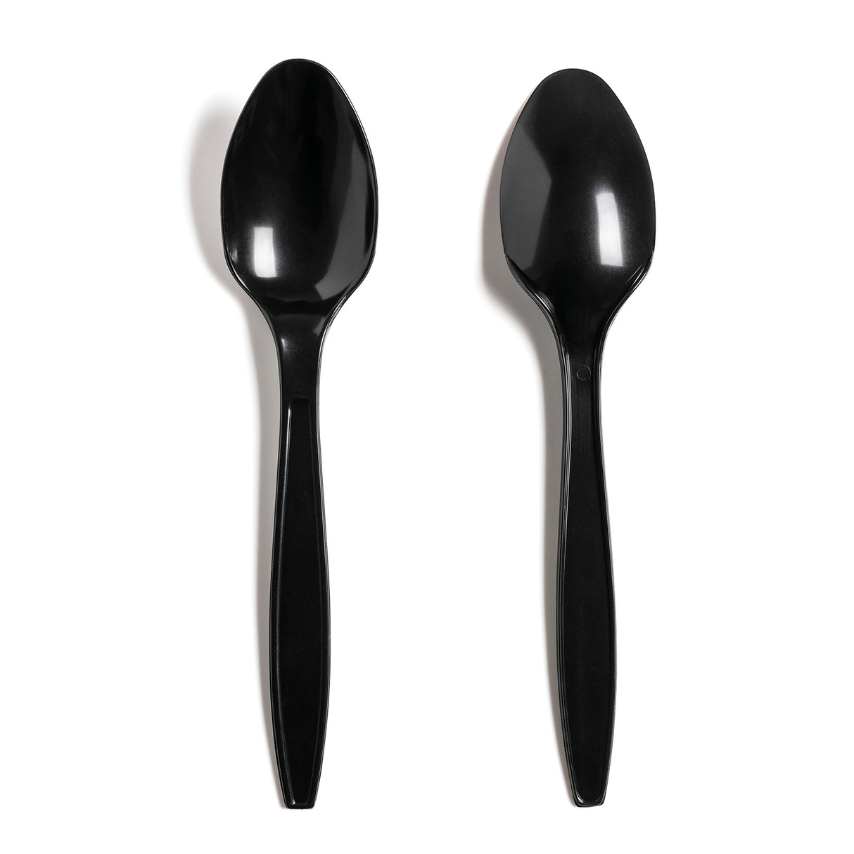 Two black disposable plastic spoons on a white background.