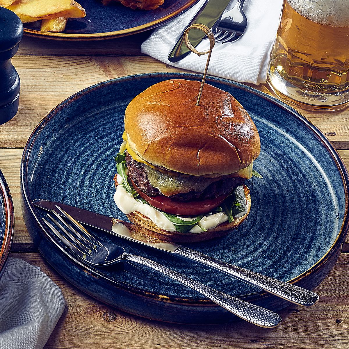 terra porcelain aqua blue round plate with a burger on it