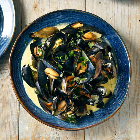 aqua blue terra porcelain round plate filled with mussels