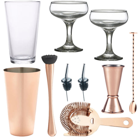 A 10-piece copper cocktail set including a shaker, strainer, jigger, spoon, muddler, pourers, and two glasses.