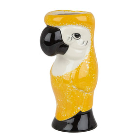 A ceramic tiki mug designed to resemble a parrot, with yellow body and black and white details on a white background.