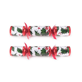 Two Christmas crackers with holly design on a white background