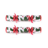Two Christmas crackers with holly design on a white background