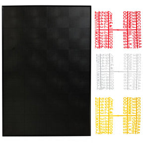 A black peg board with a set of small white, yellow, and red letters arranged in rows.