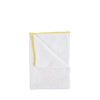White cloth with yellow trim on a white background