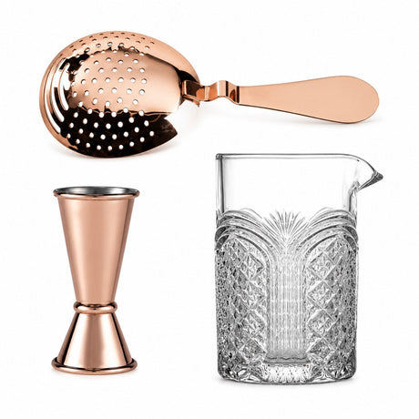 copper jigger along with copper julep strainer and astro mixing glass on a white background 