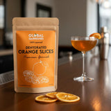 Dehydrated orange slices package by Global Garnishes on a table with a cocktail in the background