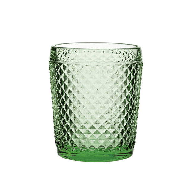 Green textured glass tumbler on a white background