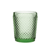 Green textured glass tumbler on a white background