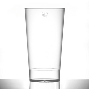 An empty clear polycarbonate drinking glass with a UKCA pint brim measurement marking.