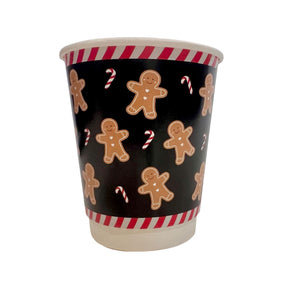 Paper cup with gingerbread man and candy cane pattern on a black background
