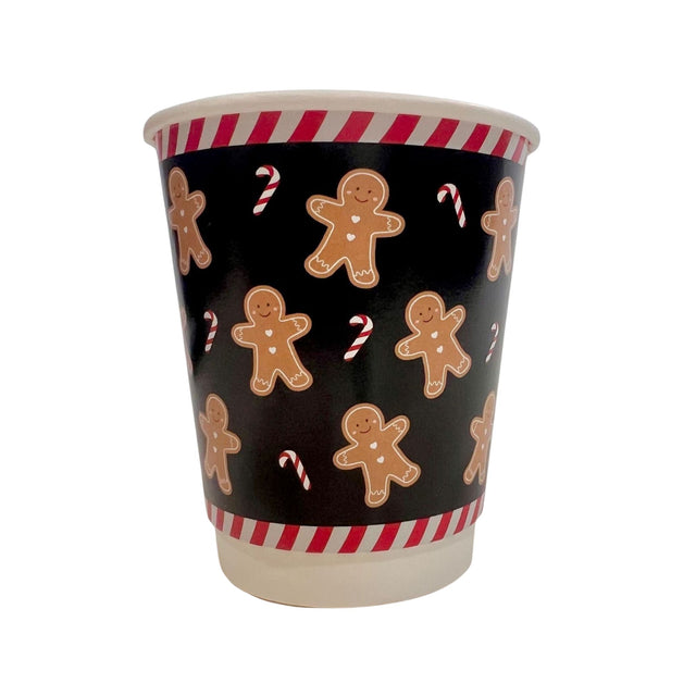 Paper cup with gingerbread man and candy cane pattern on a black background
