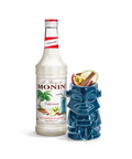 Monin Falernum Syrup bottle and a tiki glass