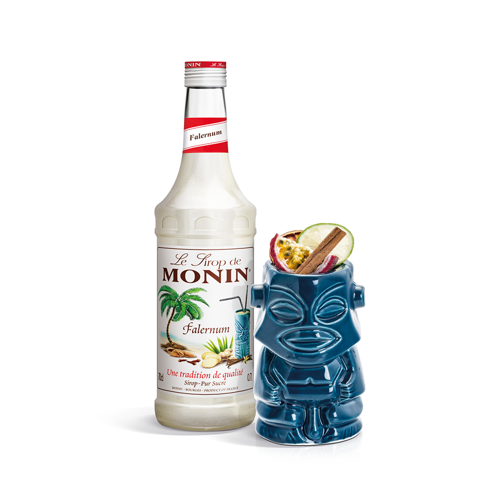 Monin Falernum Syrup bottle and a tiki glass