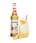 Monin Peach Syrup bottle and mason jar drink