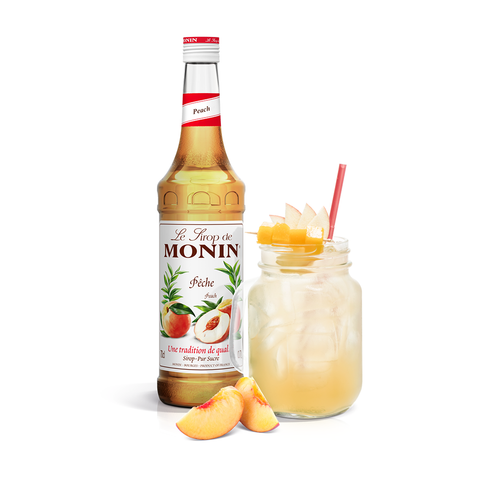 Monin Peach Syrup bottle and mason jar drink