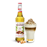 Monin Roasted Hazelnut Syrup bottle and creamy drink