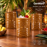 Four brown tiki-style ceramic mugs arranged on a wooden table with tropical props, including a cocktail in the center mug. The GenWare logo and text reading 'Brown Tiki Mug' and 'Pack 4' appear in the upper right, with dishwasher/food/safe icons along the bottom.