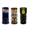 Three decorative tiki mugs with unique designs on a white background