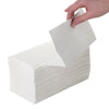 Hand pulling a white paper towel from a box on a white background