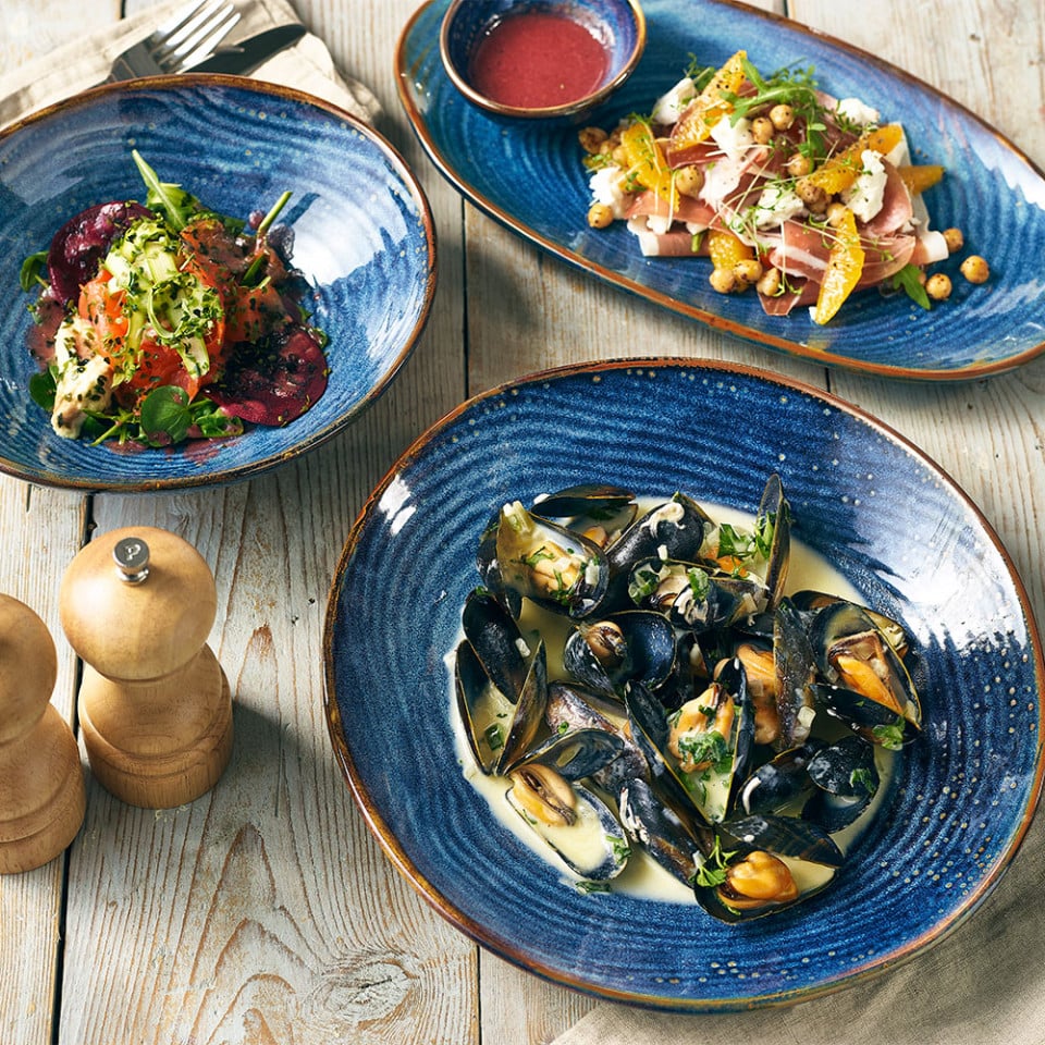 aqua blue terra porcelain dishes on a wooden table serving food