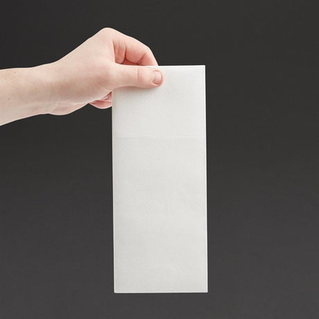 Hand holding a white rectangular napkin against a black background