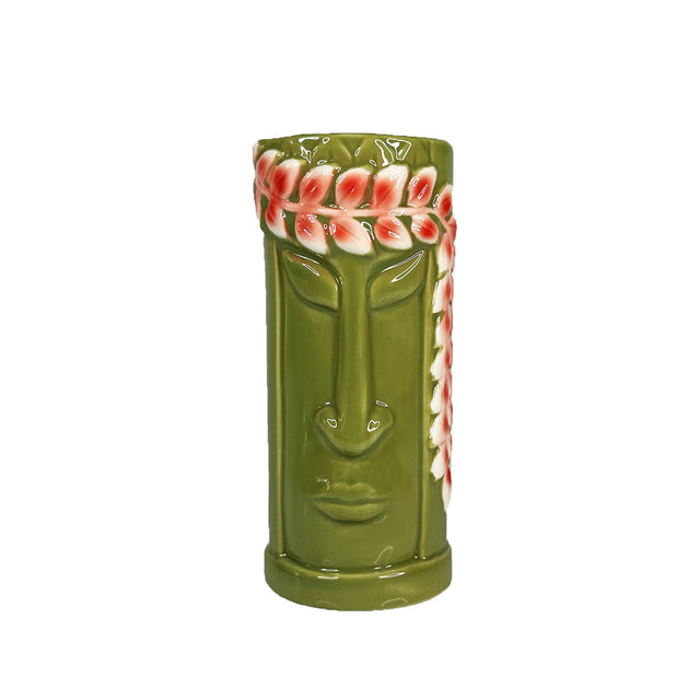 A ceramic Green Hula Tiki Mug with a playful tiki design, featuring a bright green glaze and a red and white flower crown pattern on top.