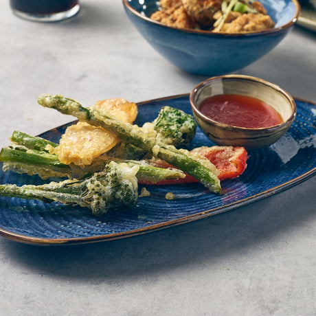 aqua blue terra porcelain organic shaped plate with b=vegetables and a bowl of dip 