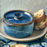 aqua blue terra porcelain pot with lid beside bread