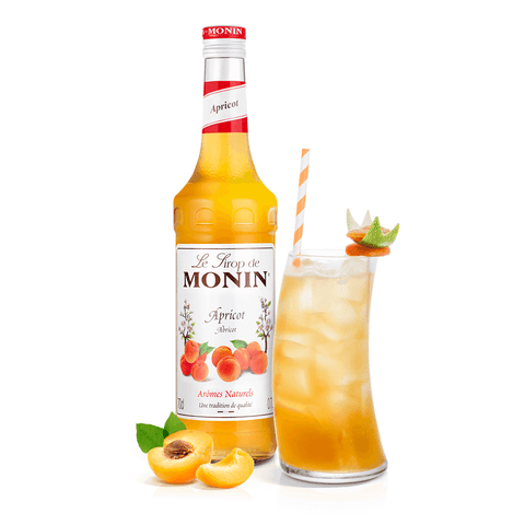 Monin apricot syrup bottle and cocktail in a long glass with straw