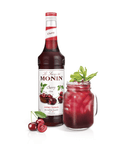 monin cherry syrup bottle and drink in a mason jar