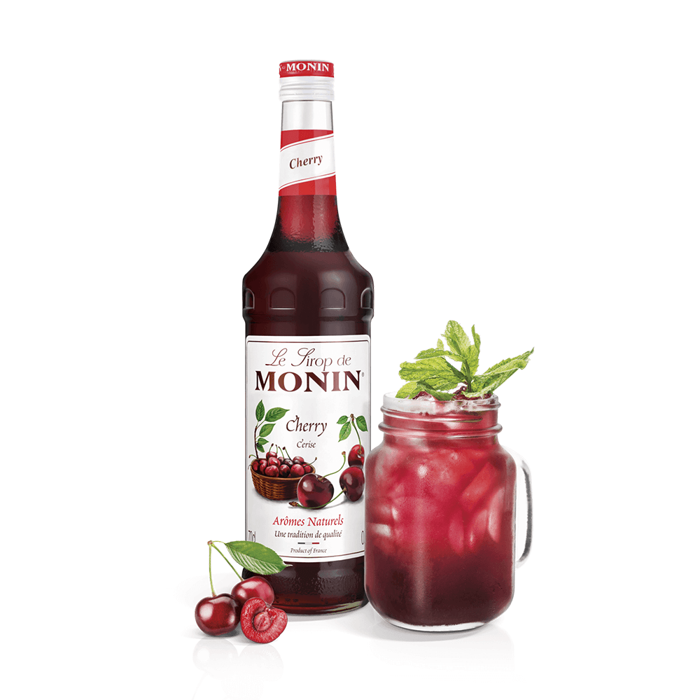 monin cherry syrup bottle and drink in a mason jar