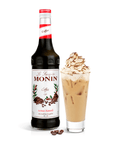 Monin coffe syrup with creamy drink in a tall glass