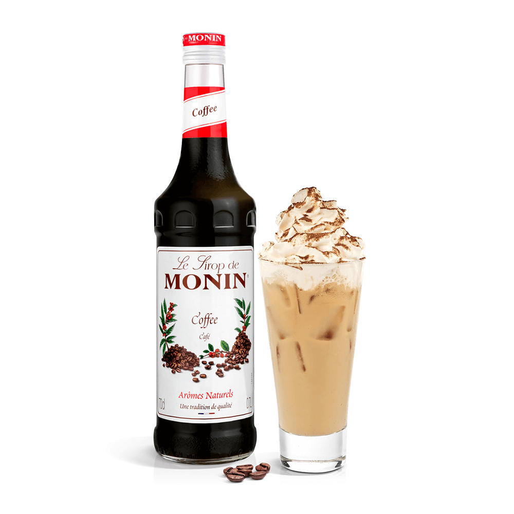 Monin coffe syrup with creamy drink in a tall glass