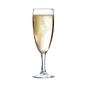 A clear sodalime glass flute with a sparkling beaded rim, filled with a golden-yellow liquid, presumably champagne.