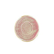 A pink and beige porcelain saucer with a rolled edge and a gold rim.